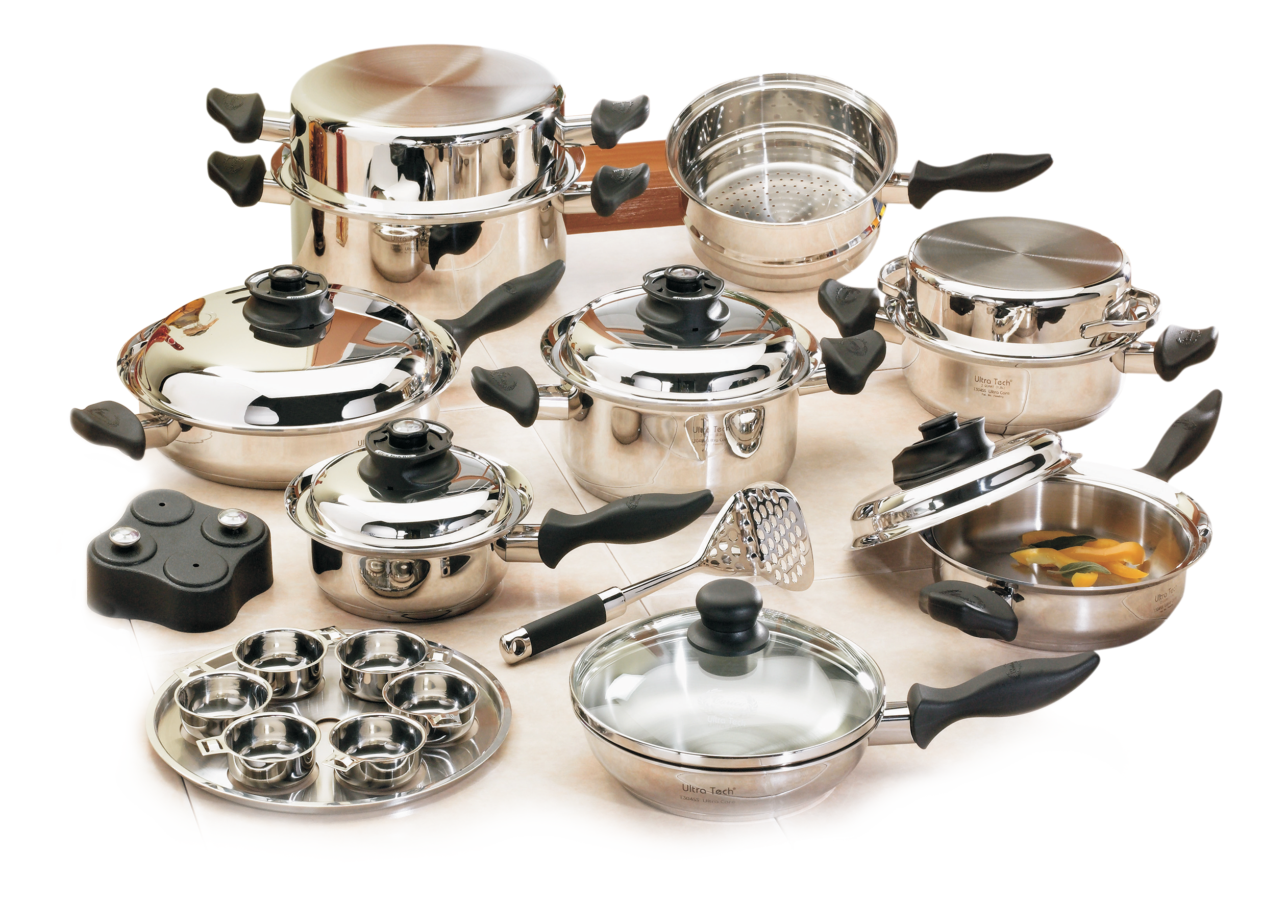 The Food You Eat 10 Full 23-piece Carico UltraTech II cookware set displayed on a kitchen counter, including pots, pans, lids, steamer insert, egg poacher, and masher.