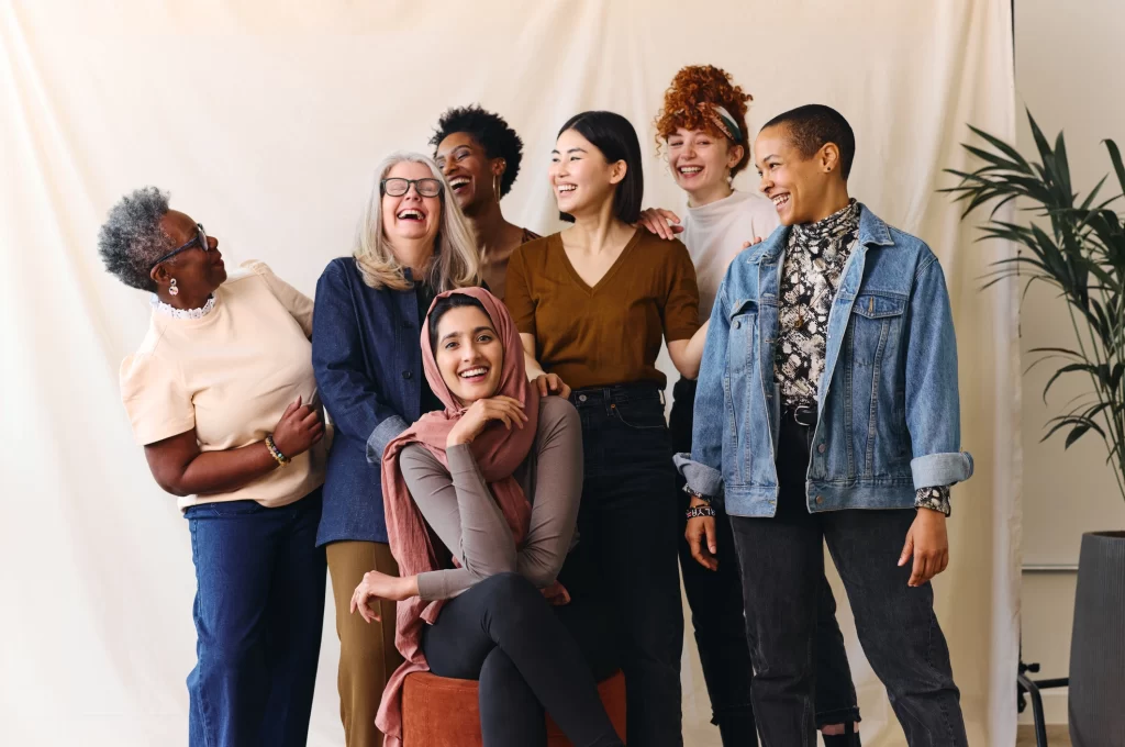 Diverse group of women smiling together in celebration of International Women’s Day